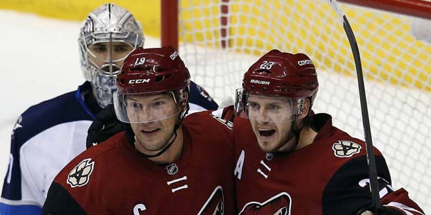 Arizona Coyotes defenseman Oliver Ekman-Larsson celebrates with Shane Doan (19) after scoring during the third period of an NHL hockey game against the Winnipeg Jets, Thursday, Dec. 31, 2015, in Glendale, Ariz. The Coyotes won 4-2. (AP Photo/Rick Scuteri)